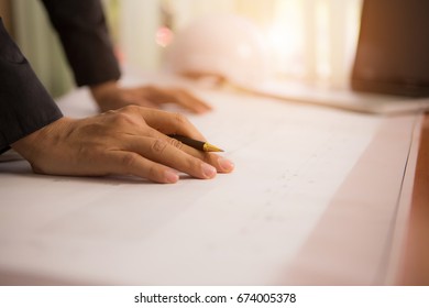 Man engineer with plan paper on desk