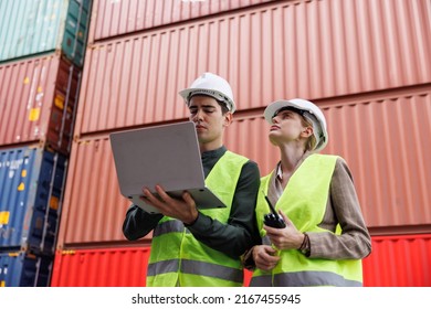 the man engineer using laptop in the import- export container shipping yard. the woman worker using walkies talkie concept : using technogy control logistic with big data analysis. - Powered by Shutterstock