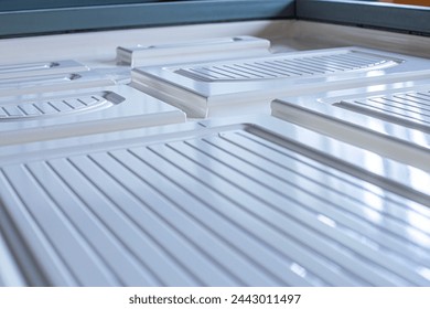 a man engineer working on a machine for sticking a film on an MDF panel close-up, the front and back background is blurred with a bokeh effect