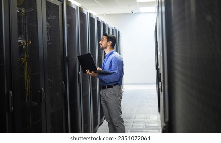 Man, engineering laptop and server room, data center inspection or system solution for cybersecurity coding. IT person on computer for cables check, business power or programming hardware in basement - Powered by Shutterstock