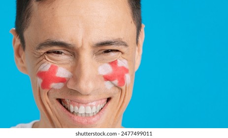 Man with a english flag painted on the face smiling - Powered by Shutterstock