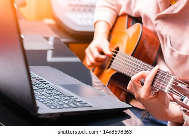 Man Enjoy Learning Online Guitar Lesson From Internet