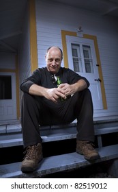 Man Enjoying A Beer On His Front Porch - Dark Mood