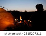 Man enjoying camping at sunset