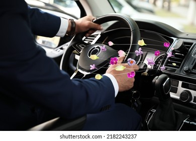 Man enjoying driving car feeling flower scent from ventilation, closeup. Air freshener