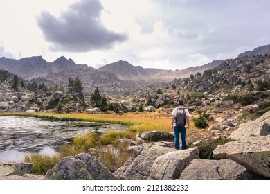 Man Enjoying A Natural Mountain Landscape In The Pyrenees, Andorra, Estany Pessons