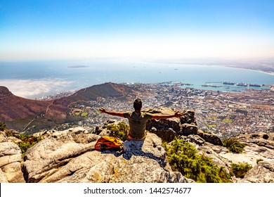 Man enjoying panoramic view of Cape Town from the top of Table Mountain National Park in Western Cape, South Africa.