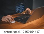 Man entering PIN code while holding a credit card, with virtual numeric keypad on screen. Concept of secure online payment, cybersecurity, internet banking, and digital transaction authentication.
