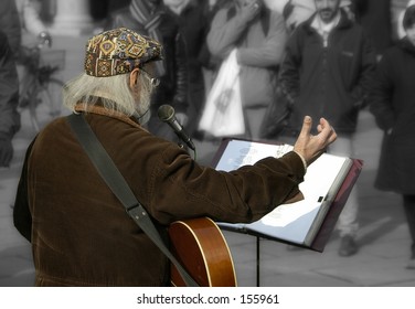 Man entertaining the crowds.  Background converted to b&w and softened.  No recognizable faces.