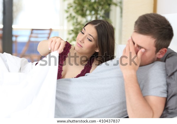 Man with erectile dysfunction during sex\
with her partner looking\
disappointed