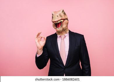 Man with euphoric lizard head and fingers with ok symbol
