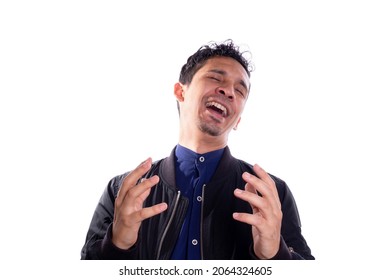 Man With Evil Laugh Isolated On White Background. Young Latin Adult Young Man Expressing Evil With His Hands And Laughter. Expression Of Happy Villain.