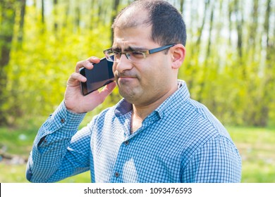  Man Excitedly Talking On The Phone Outdoors 