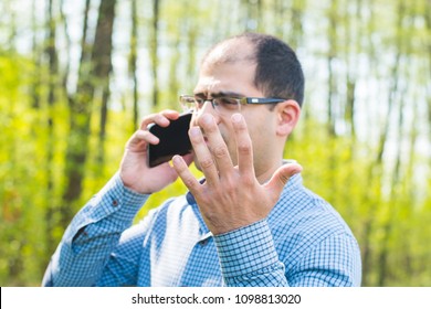  Man Excitedly Talking On The Phone Outdoors 