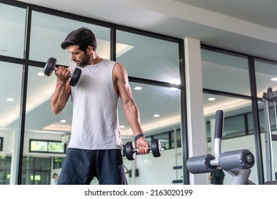 Man Exercise With Dumbell Lifting Bicept Alone In Fitness