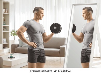 Man exercising with a dumbbell in front of a mirror in a living room