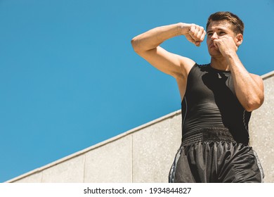 Man Exercising And Fighting In Outside, Boxer In Gloves. Male Boxer Portrait