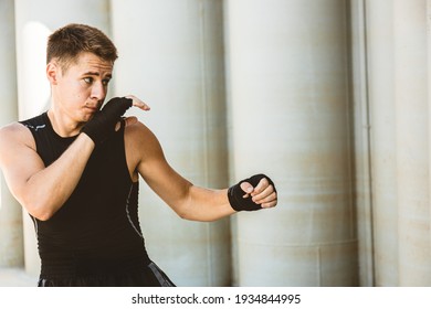 Man Exercising And Fighting In Outside, Boxer In Gloves. Male Boxer Portrait