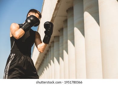 Man Exercising And Fighting In Outside, Boxer In Gloves. Male Boxer Portrait