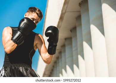 Man Exercising And Fighting In Outside, Boxer In Gloves. Male Boxer Portrait