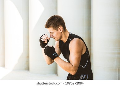 Man Exercising And Fighting In Outside, Boxer In Gloves. Male Boxer Portrait