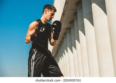 Man Exercising And Fighting In Outside, Boxer In Gloves. Male Boxer Portrait