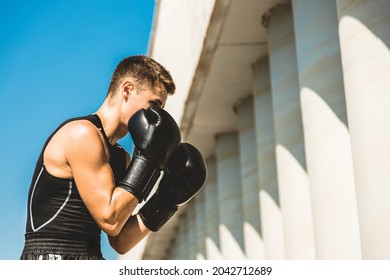 Man Exercising And Fighting In Outside, Boxer In Gloves. Male Boxer Portrait