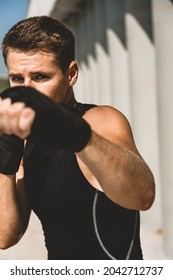 Man Exercising And Fighting In Outside, Boxer In Gloves. Male Boxer Portrait