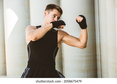 Man Exercising And Fighting In Outside, Boxer In Gloves. Male Boxer Portrait