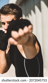 Man Exercising And Fighting In Outside, Boxer In Gloves. Male Boxer Portrait