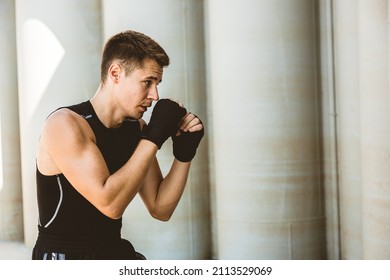 Man Exercising And Fighting In Outside, Boxer In Gloves. Male Boxer Portrait