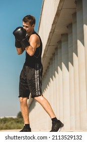 Man Exercising And Fighting In Outside, Boxer In Gloves. Male Boxer Portrait