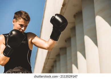 Man Exercising And Fighting In Outside, Boxer In Gloves. Male Boxer Portrait