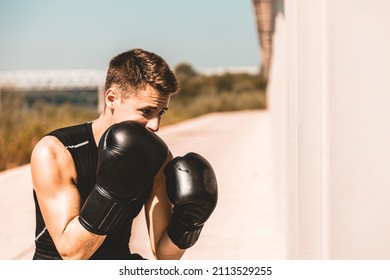 Man Exercising And Fighting In Outside, Boxer In Gloves. Male Boxer Portrait