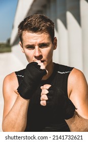 Man Exercising And Fighting In Outside, Boxer In Gloves. Male Boxer Portrait