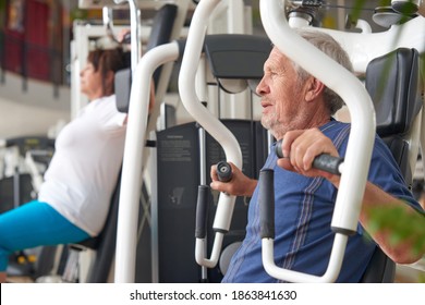 Man exercising at gym. Senior athlete doing chest exercises on vertical bench press machine. Strength training benefits for ageing bodies.