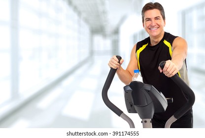 Man Exercising On Elliptical Trainer.