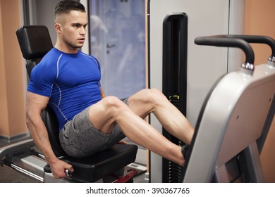 Man Exercising On Leg Press Machine