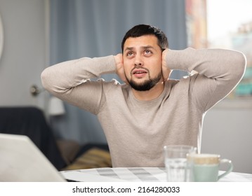 Man Experiencing Headache After Working Long Hours On Laptop At Home