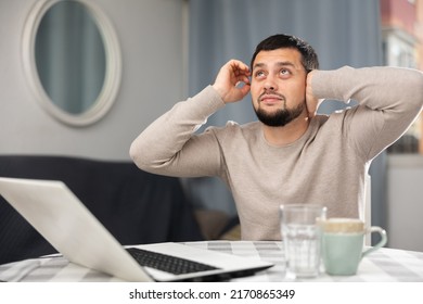 Man Experiencing Headache After Working Long Hours On Laptop At Home