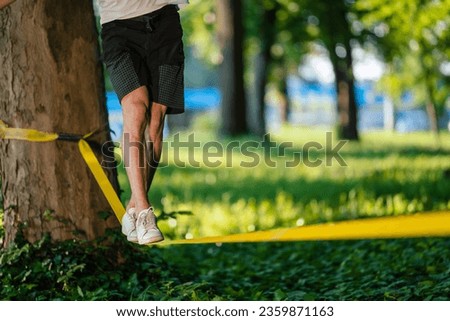 Man experiencing slacklining in the park