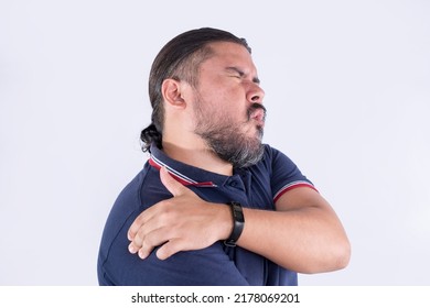 A man experiencing a stiff shoulder. Frozen shoulder, also known as adhesive capsulitis. Exaggerated facial reaction. - Shutterstock ID 2178069201