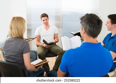 Man Explaining To His Friends From Scripture