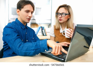 Man Explaining Something To Woman At Working Place 