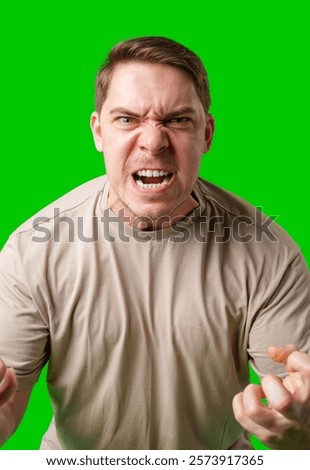 Man expressing intense frustration while standing against a bright green background