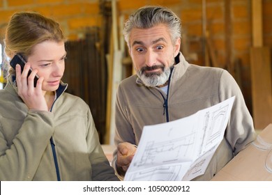 Man With Expression Of Incomprehension While Looking At Paperwork