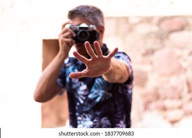 A Man Extends His Open Hand Towards The Camera While Taking A Photo. Selective Focus. Photography Concept