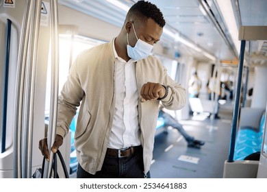 Man, face mask and check time for train travel with ppe compliance, metro safety and transport protocol. Person, watch and running late with delay, covid19 control and commute protection for schedule - Powered by Shutterstock