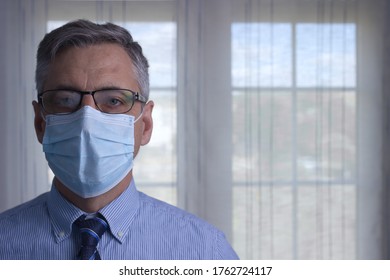 Man With Face Mask, Foggy Glasses And Tie With Background Window