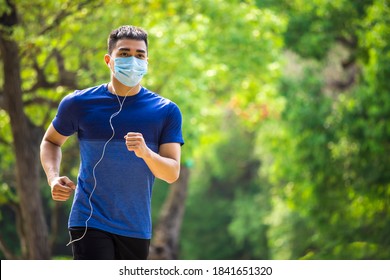  man in face mask and running in the park - Powered by Shutterstock